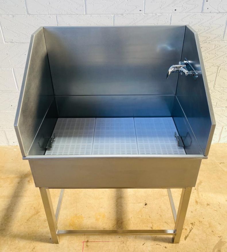 A stainless steel freestandinng sink which was designed as a dog bath