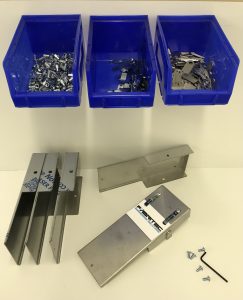 some fabricated metal parts shown with washers and fixings.